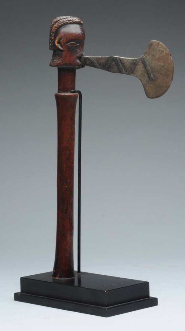 African War Axe with Carved Wooden Head.: The axe is mounted on a stand. Condition (Excellent). Size 18" T.
