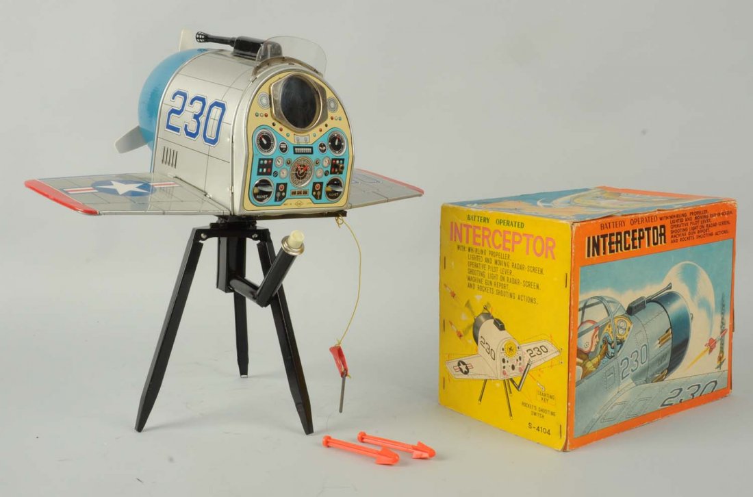 Japanese Interceptor Airplane Toy.: battery-operated, includes original stand, and is complete with key. Marked "S&E Japan". Very intricate toy. Includes nice color lithography box. Box has some paper loss on front as well as some creas