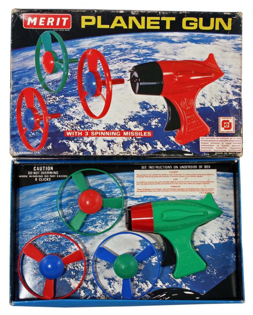 Planet Gun Flying Saucer Pistol.: In box, circa 1970s, Merit, England. Contains plastic spring loaded gun and three saucers. The gun says "Dan Dare" and is a re-issue of the 1950s Park Plastics toy. Photo box. Condition (C8 Excellent 