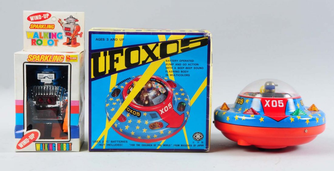 Lot of 2: Plastic Space Toys.: One toy is battery-operated, the other is wind-up. Both toys are in their original boxes. One toy is a Sparkling Walking Robot that was made in Hong Kong, and the other is a battery-operated, Japanese