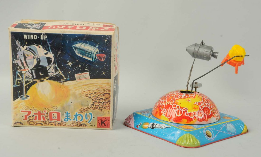 Japanese Tin Litho Wind-Up Lunar Space Toy.: The toy includes its original box with a nice space scene, and is made by K Japan. The toy is a combination of tin litho base with plastic module and space capsule. When in operation, the capsule and 