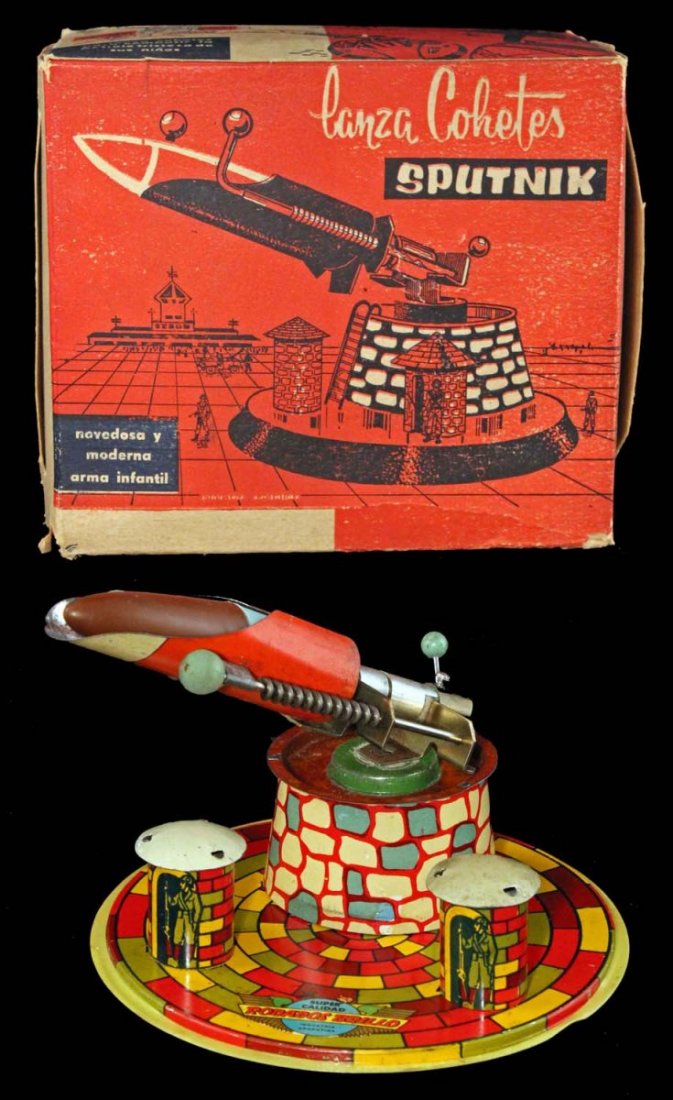 Sputnik Rocket Launcher in Box.: Circa 1950s, Argentina, Lanza Cohetes Sputnik. Tin lithographed missile launcher with spring loaded, cap-firing plastic missile on colorful base. Complete with instruction sheet. A cool toy from the s