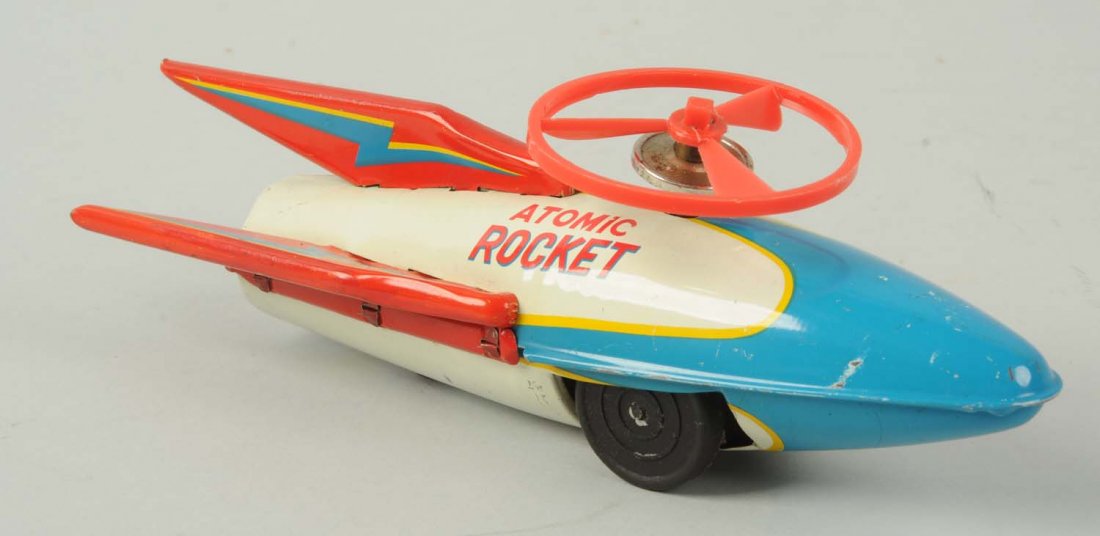 Japanese Tin Litho Friction Atomic Rocket Toy.: The box is marked "Modern Toys Japan". The toy comes with a plastic disc on top that looks original, but not to this toy. It has nice lithography and says "Atomic Rocket" on both sides. There is some 