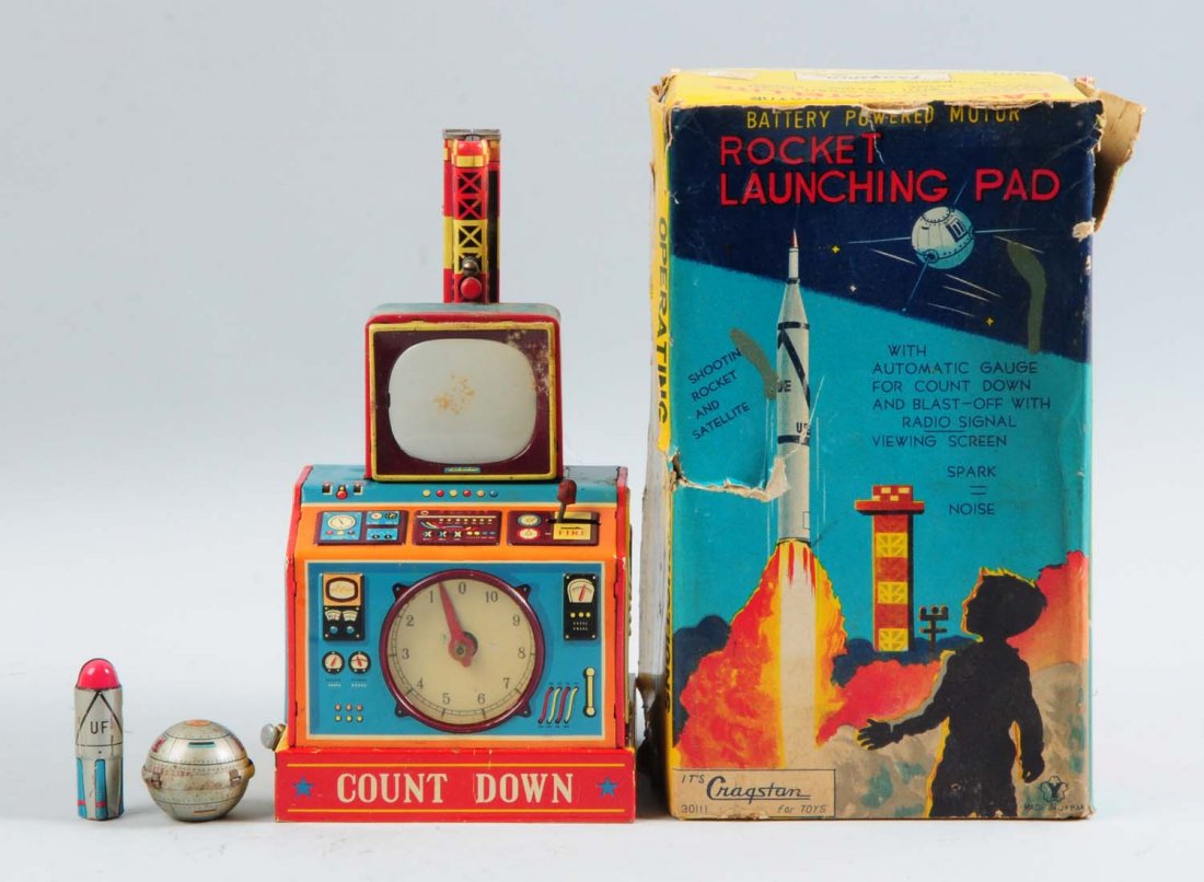 Tin Litho Rocket Launching Pad Toy.: Japanese. Battery-operated. The toy includes its original box, which has the cardboard inserts, and some staining and tearing. The toy also has its original tin litho satellite and rocket. It is compl