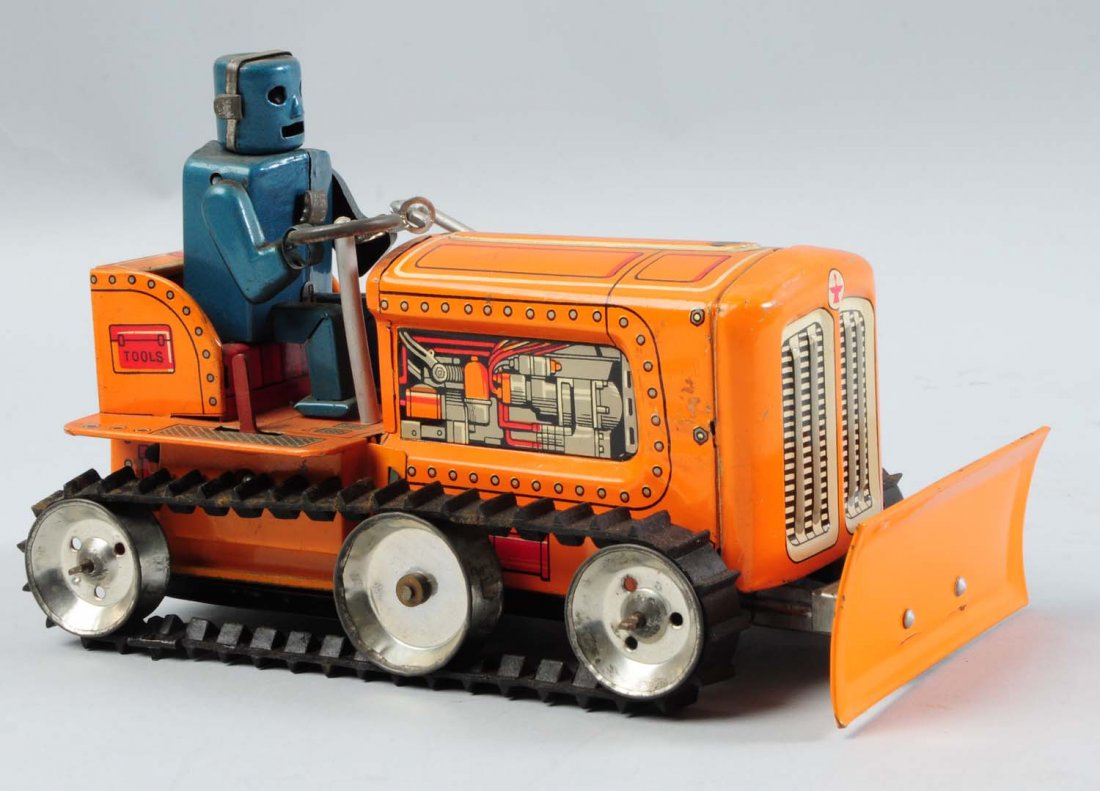 Japanese Tin Litho Robot Driving Tractor Toy.: Battery-operated. One of the more difficult versions to find. Beautiful tin litho with full dimensional robot driver. Original rubber treads marked "KO Japan" on back. Also has lever for go, stop, and