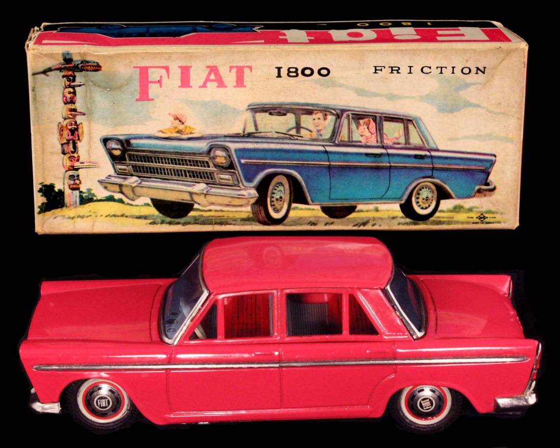 1964 Fiat 1800 4 Door Sedan.: In box, circa 1960s, Daiya, Japan. Tin friction, unusual hot pink color with box featuring a Native American Totem Pole. Near mint in an excellent box, which has one corner split. Condition (C8 Excell