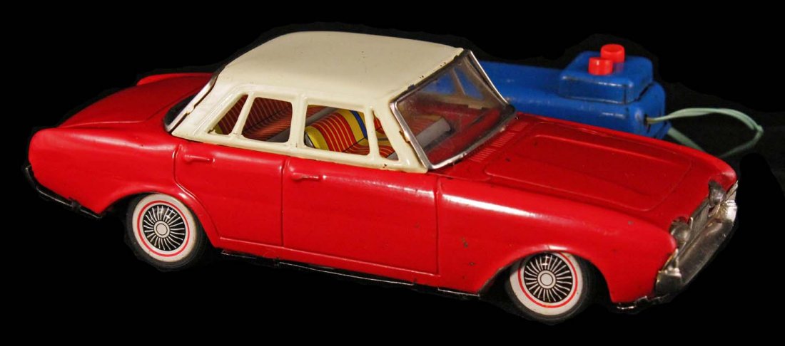 1962 Ford Tanus Toy.: Circa 1960s, M, Japan. Red and beige tin battery-operated remote control. Condition (C8.5 Excellent Plus). Size 8" L.