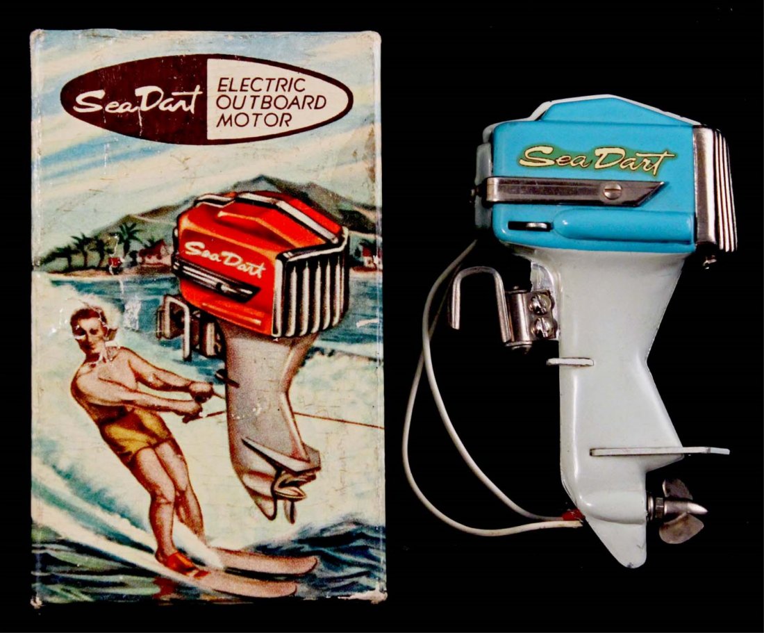 Japanese Sea Dart Electric Outboard Motor.: In box. Circa 1950s. Metal and plastic miniature battery operated outboard engine. Missing screw for attaching clamp. Colorful box with a hole punched in top. Condition (C7.5 Very Good - C9 Near Mint)