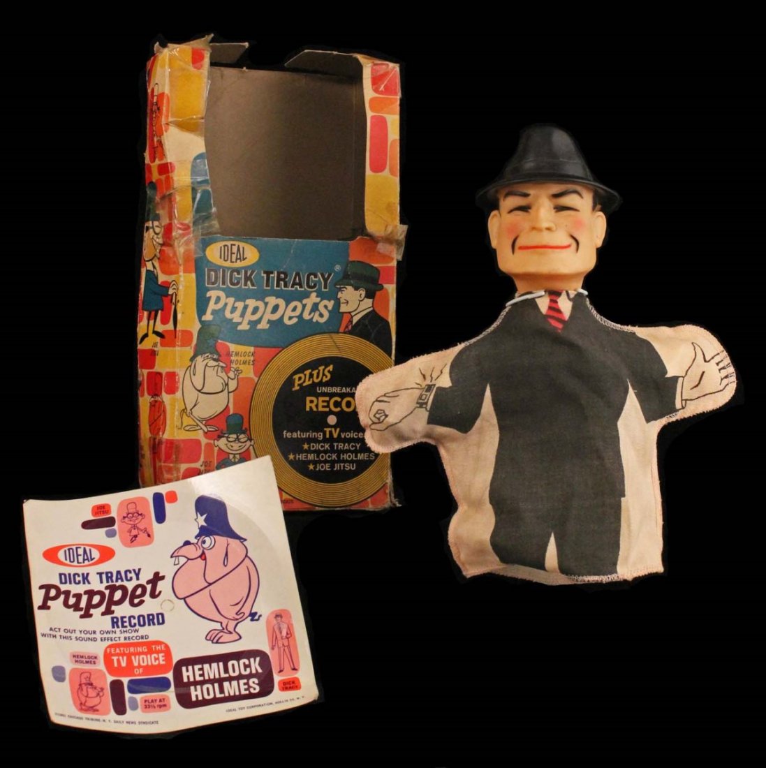 Dick Tracy Hand Puppet.: In box. Circa 1961, Ideal. Painted vinyl head and fabric body, includes "Unbreakable Record", near mint in box, which is missing top flap and has outside clear tape. Condition (C6 Good - C9.5 Near Min