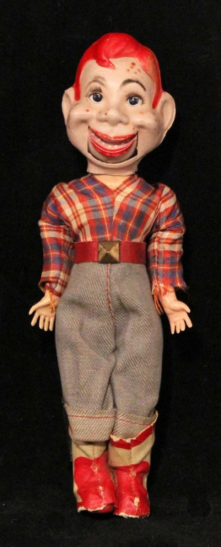 Howdy Doody Mini Ventriloquist Doll.: Circa 1950s, unmarked. Composition head and body with plastic arms and cloth clothes; jaw moves via lever in back of head; head and arms have detached, but can be re-strung with rubber bands, some edg