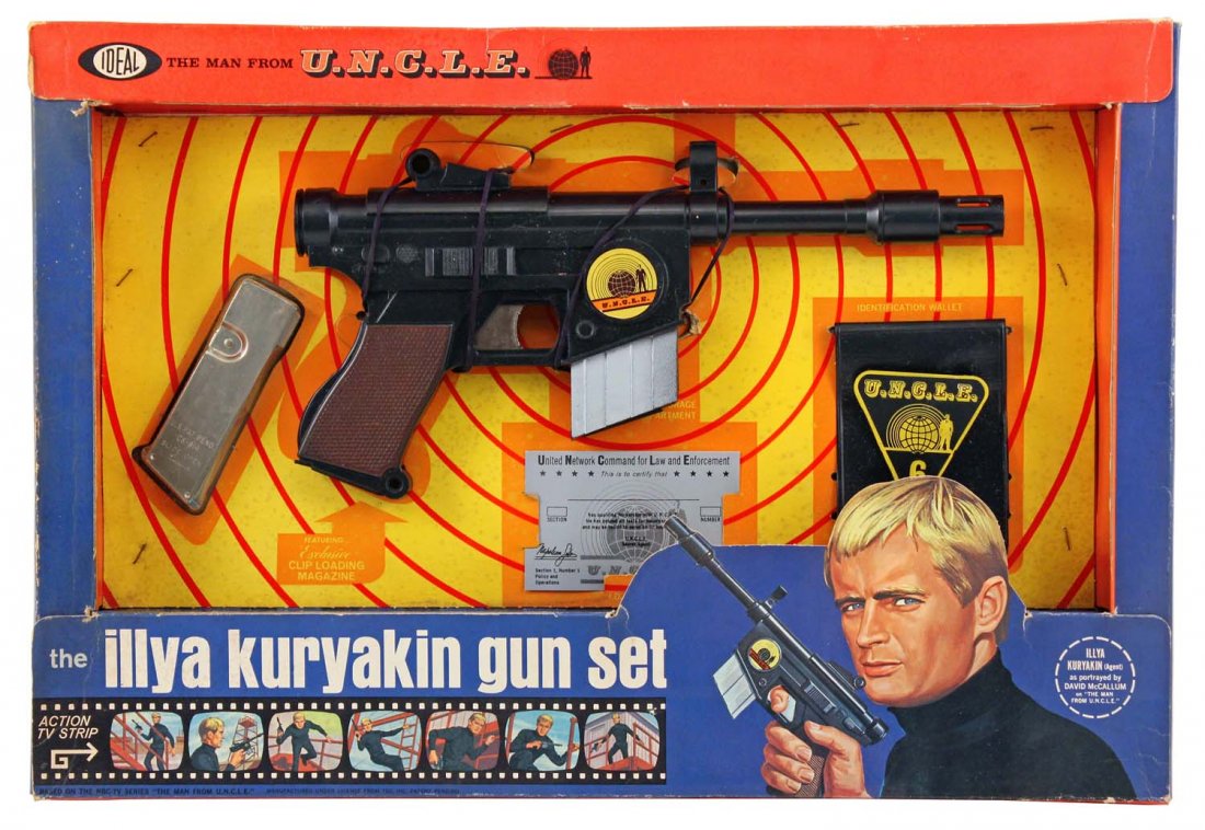 The Man from U.N.C.L.E. Illya Kurakin Gun Set.: Circa 1966, Ideal Toys, US. Colorful, die cut box contains a 13” molded plastic pistol, a metal ammo clip, a vinyl wallet with a molded plastic badge, and a printed ID card; ammo clip is still facto