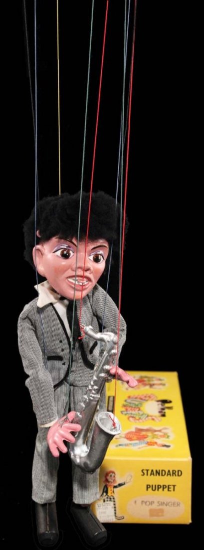 Unlicensed Beatles Pop Singer No. 1 Marionette.: Sax player in box, circa 1964, Pelham Puppets, England; figure has composition head, hands, feet, and instrument; flocked 'mop-top' hair, dressed in a light grey Beatles-esque suit; complete as issued