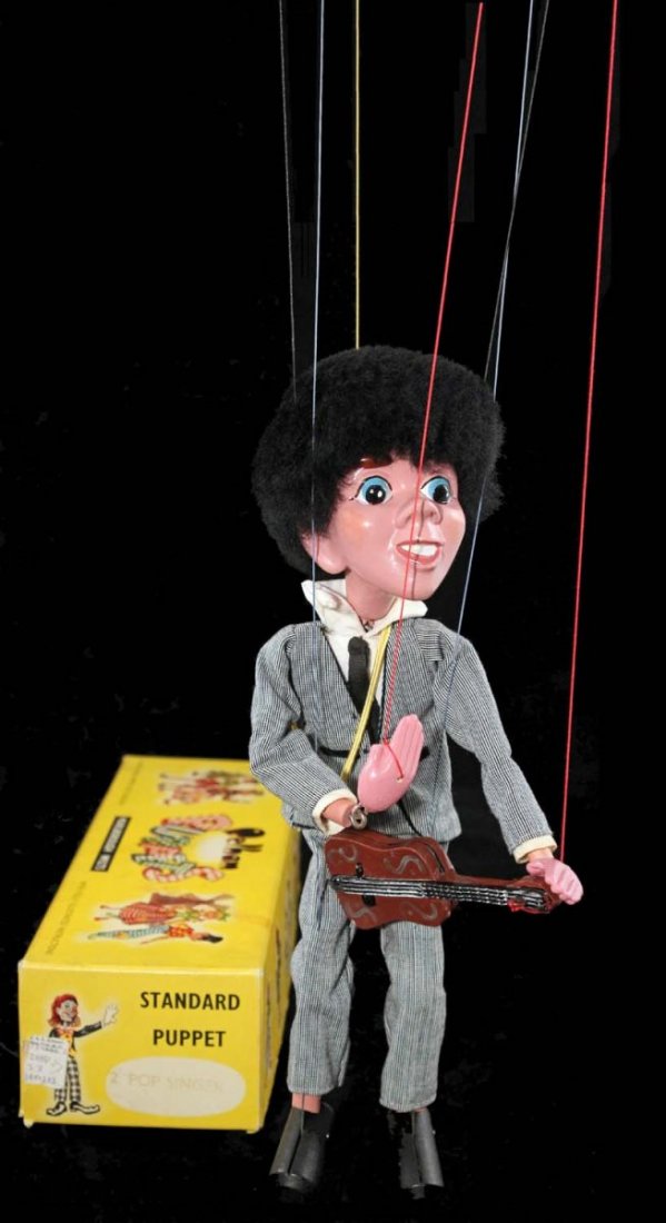 Unlicensed Beatles Pop Singer No. 2 Marionette.: Guitar player marionette in box, circa 1964, Pelham Puppets, England. The figure has composition head, hands, feet, and instrument; flocked 'mop-top' hair, dressed in a light grey Beatles-esque suit;