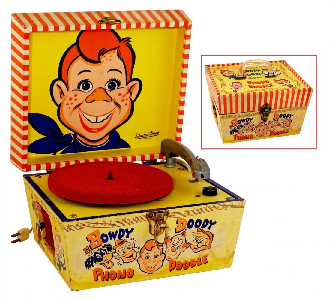 Howdy Doody Phono Doodle Portable Record Player.: Circa 1958, Shura–Tone. Electric, red plush turntable with cast aluminum arm, in wood case with colorful paper labels; outside shows light water stains and slight sun fade, mostly to bottom front pa