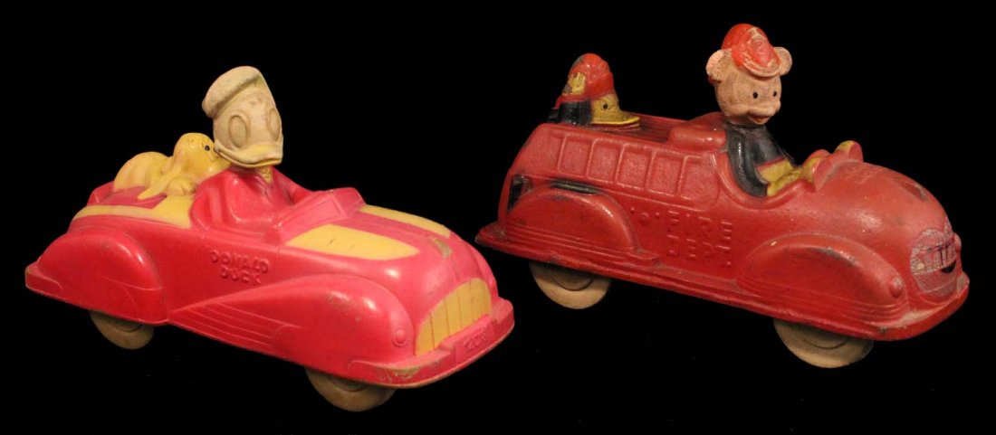 Lot of 2: Rubber Disney Character Vehicles.: CIrca 1950s. Includes Donald Duck and Pluto roadster #12018. Viceroy, Sun Rubber, Canada. Almost no paint remaining on Donald's head, otherwise clean. Also includes Mickey Mouse and Donal Duck fire tr
