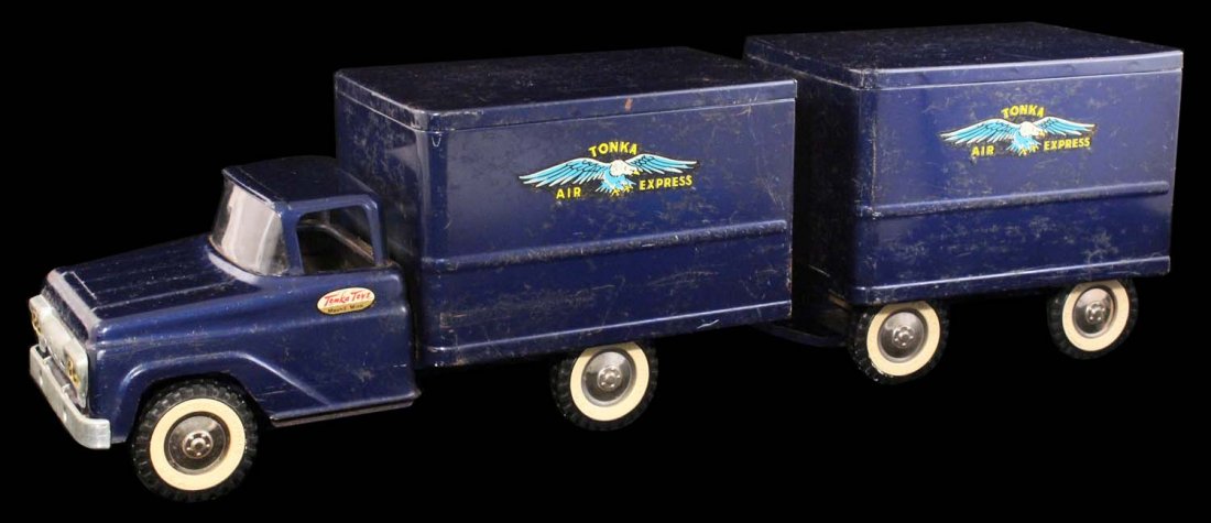 Tonka Air Service Truck & Trailer Toy.: Circa 1950s. Painted pressed steel. A large amount of scratches, pitting and crazing on all surfaces. Decals are clean, but possibly replaced. Missing one door handle. Scarce. Condition (C7 Very Good)