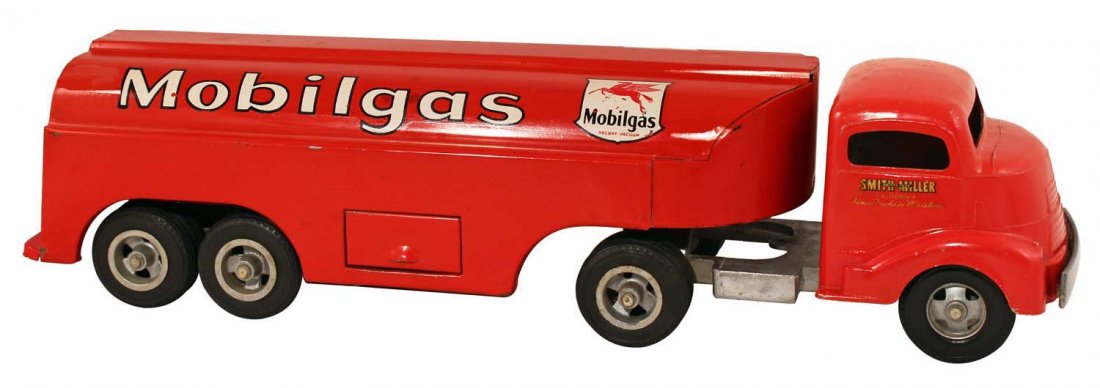 Smith-Miller Mobilegas Tanker Truck Toy.: Circa 1950s. Die-cast cab with pressed steel trailer. Features the Mobilgas flying horse logo. There are only scuffs and a few small chips on the cab, but this toy has a large area of damage with all