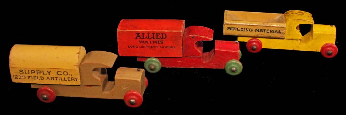 Lot of 3: Stombecker Wood Vehicles.: Circa 1920s. Painted wood with printed names on sides. Sold separately, but are compatible with the #210 Auto Carrier. Includes Supply Co. U.S. Field Artillery, Allied Van Lines Long Distance Moving a