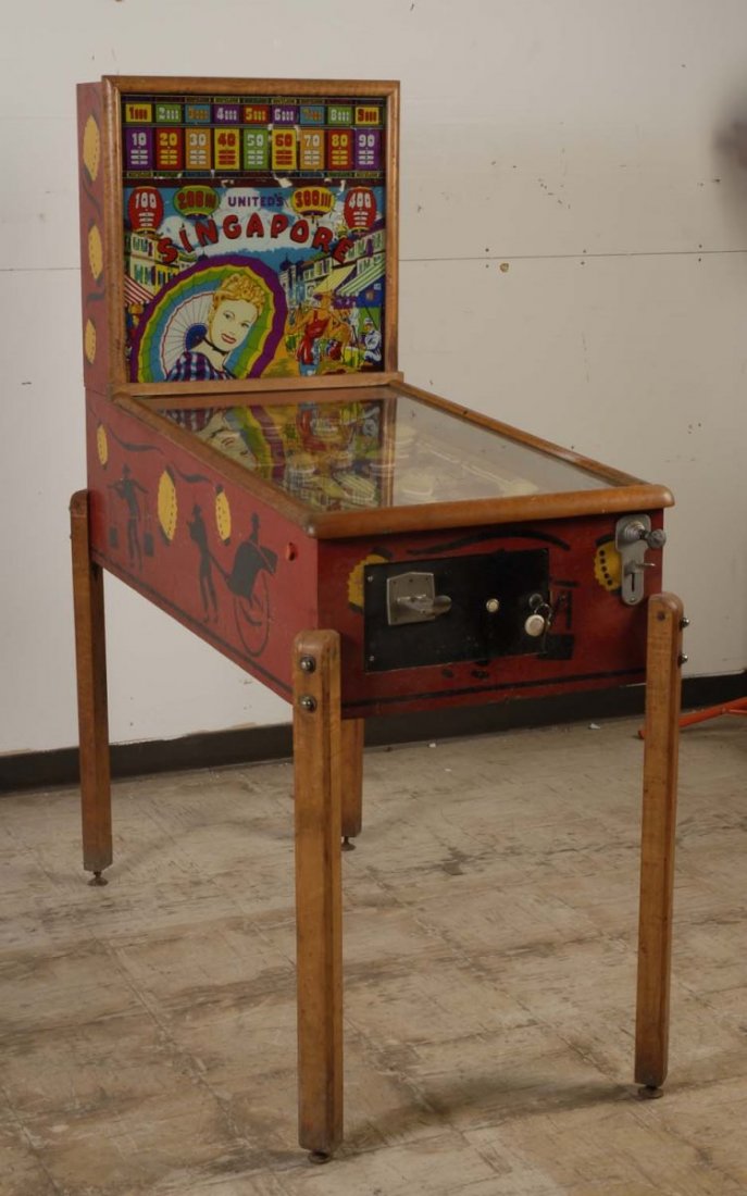 1947 United Singapore Pinball Machine.: The playfield is excellent with plastic caps that have been touched up. The back glass is fair with some flaking and peeling. The cabinet is good and original with some scrapes. Cabinet has an incorre