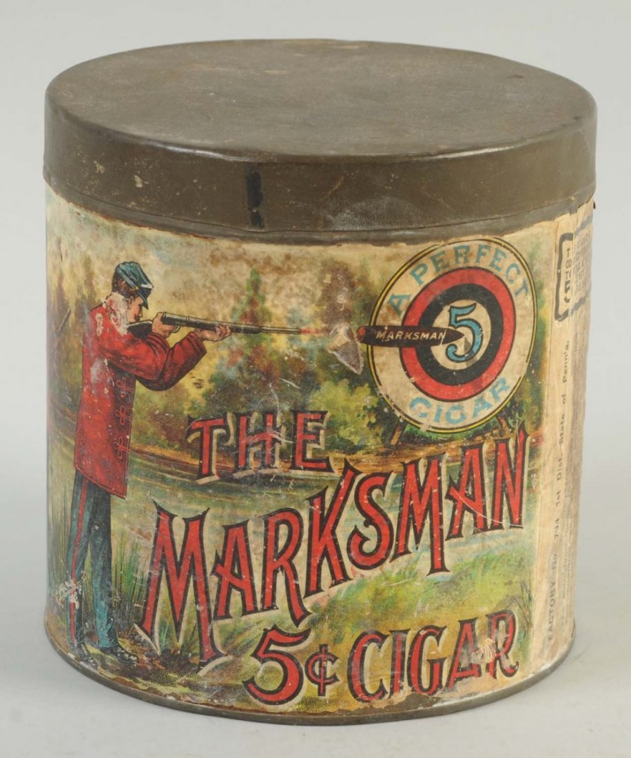 The Marksman Cigar Tin.: Paper label. Piece not seen very often. Displays well with modest amounts of wear throughout. Condition (Excellent). Size 5" L.