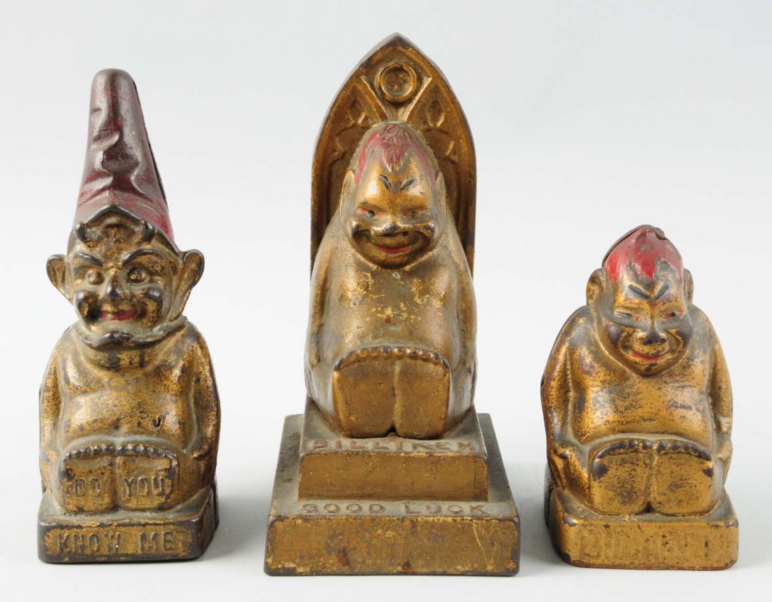 Lot of 3:Cast Iron Still Banks.: Includes a small seated Billiken, a large seated Billiken, and a seated elf bank. Condition (Very Good). Size Largest : 6 -1/2" L.
