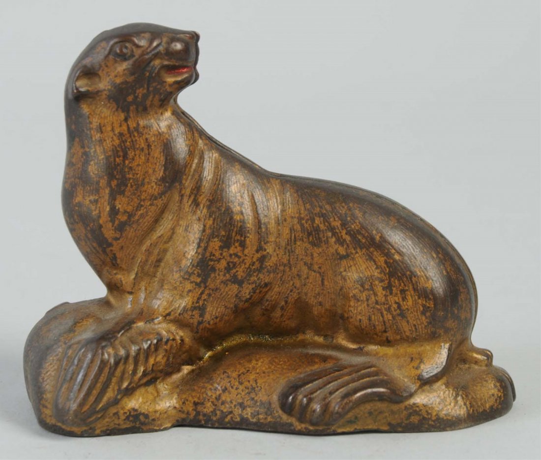 Seal on Rock Cast Iron Still Bank.: Manufactured by A.C. Williams and Company. Condition (Very Good). Size 4" L.