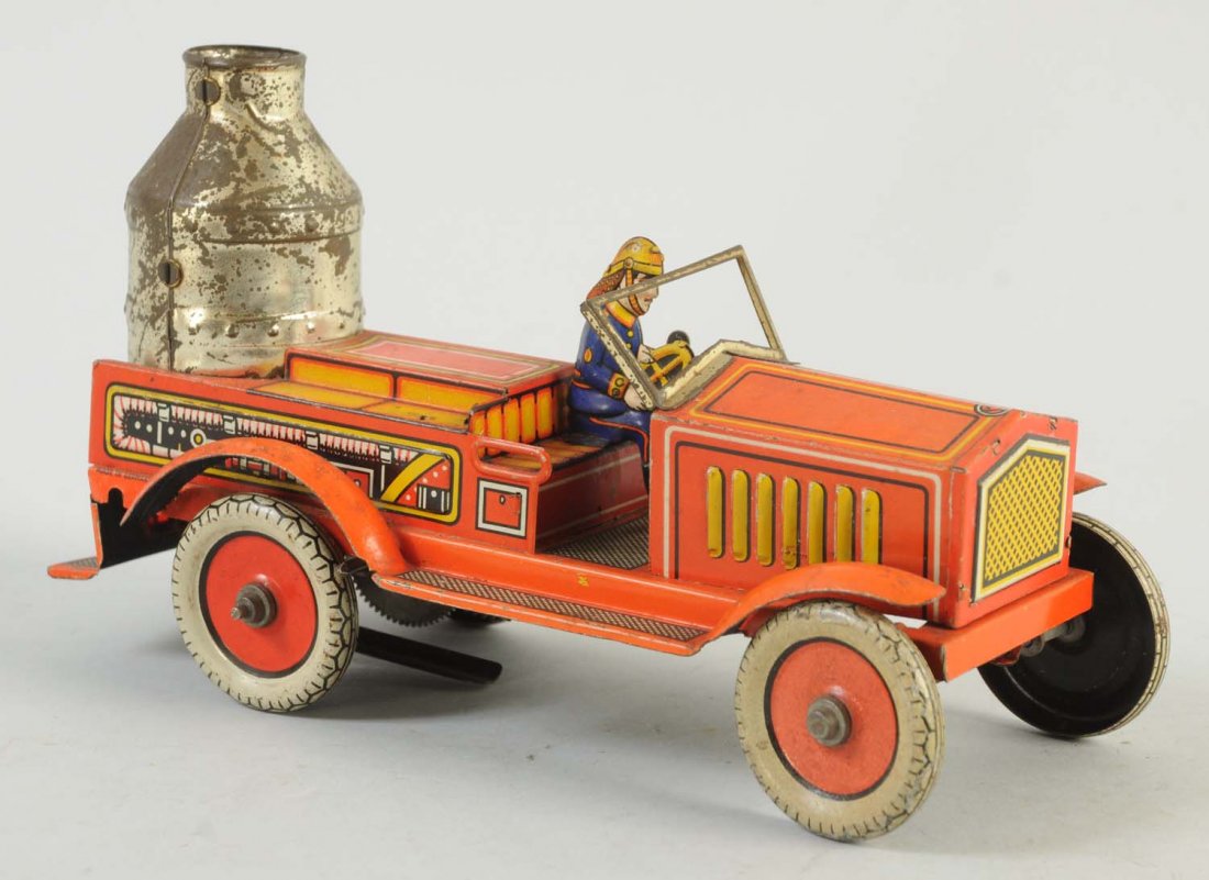 German Tin Wind-Up Fire Truck.: Toy has some significant scratches and chips throughout the top portion. The boiler has significant paint loss. Otherwise the truck has nice colors. Includes original driver.