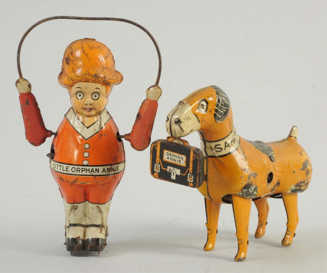 Marx Tin Wind-Up Little Orphan Annie & Sandy.: Little Orphan Annie toy has some small scratches throughout and slight oxidation to both of her arms. Sandy also has some slight scratches to the litho throughout, but otherwise they both have