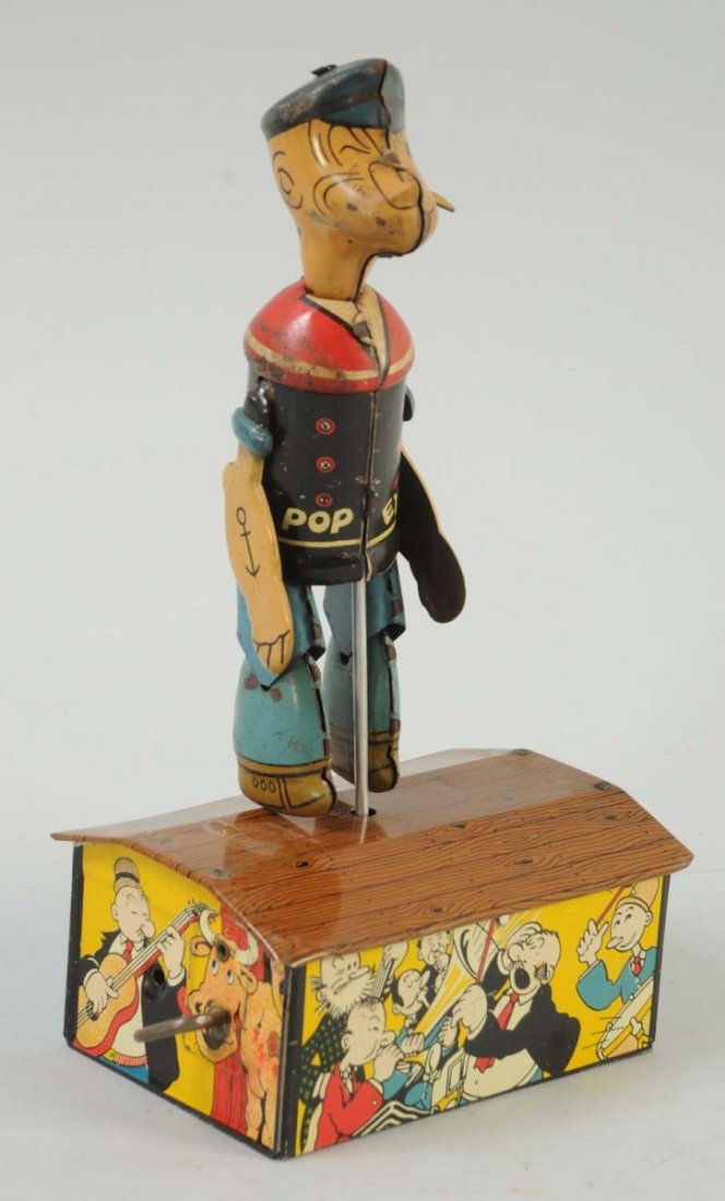 Marx Tin Wind-Up Popeye Dancer Toy.: Some very minor scratches, mainly towards the roof of the house, and to his clothing. Slight oxidation around the arms and face. Otherwise, the colors are bright and attractive. Graphics of