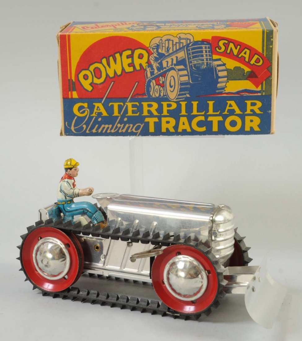 Marx Tin Wind-up Climbing Tractor Toy.: Includes original box, original tin driver, front plow and rubber treads on both sides. Tractor has no visible scratches. Very clean. Rubber treads are in great condition. Some small paper tears,