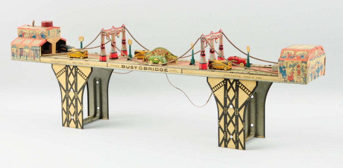 Marx Tin Wind-Up Busy Bridge.: The toy has some very minor scratches throughout, and a small dent around the wind-up mechanism. Six tin vehicles are included on the bridge, along with tin accessories.