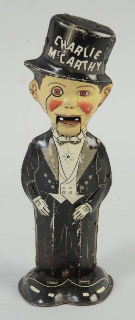 Marx Tin Wind Up Charlie McCarthy Toy.: Numerous scratches throughout the toy, especially to the back of Charlie McCarthy. One small section towards the bottom of his pants on the front, he has slight oxidation. Otherwise, mainly black