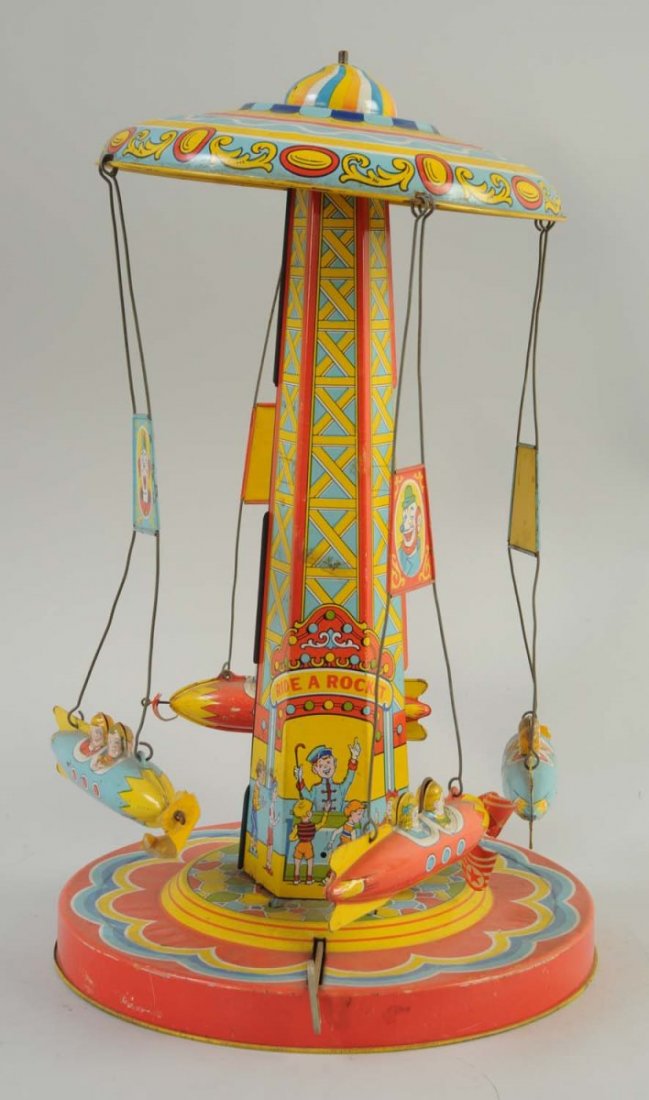 J. Chein Tin Wind-Up Ride-A-Rocket Toy.: Includes four original tin rockets with two tin kids in each rocket. Some scratches to the litho, mainly to the bottom and base of the toy, and also to the top roof of the toy. The rocket propellers
