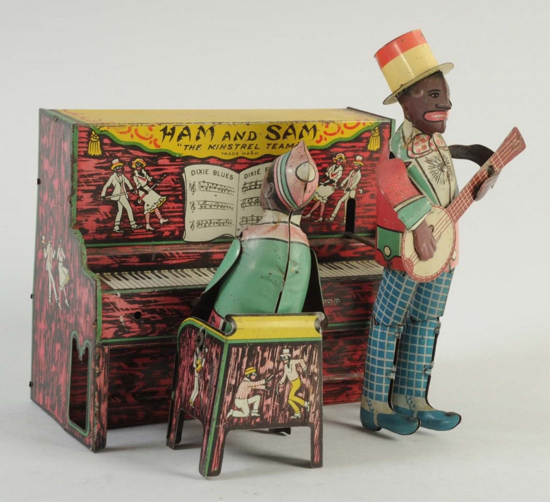 Ferdinand Strauss Co. Tin Wind-Up Ham And Sam.: Includes musician and the piano. Minor scratches to the litho, mainly to the edges of the piano. Tin figures have moving arms, legs, guitar and hat. Very interesting, interactive toy. Piano has