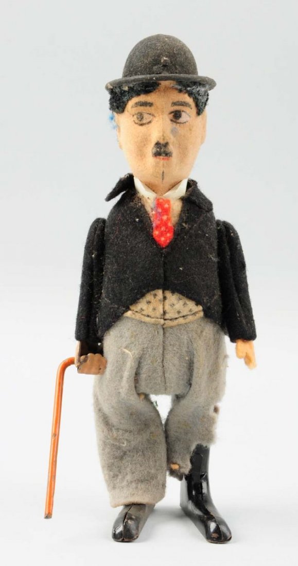 Charlie Chaplin Doll Toy.: Some significant deterioration to the clothing, and part of his jacket collar is glued, but is still attached. One side of his pants are torn and the pieces are detached and not present.