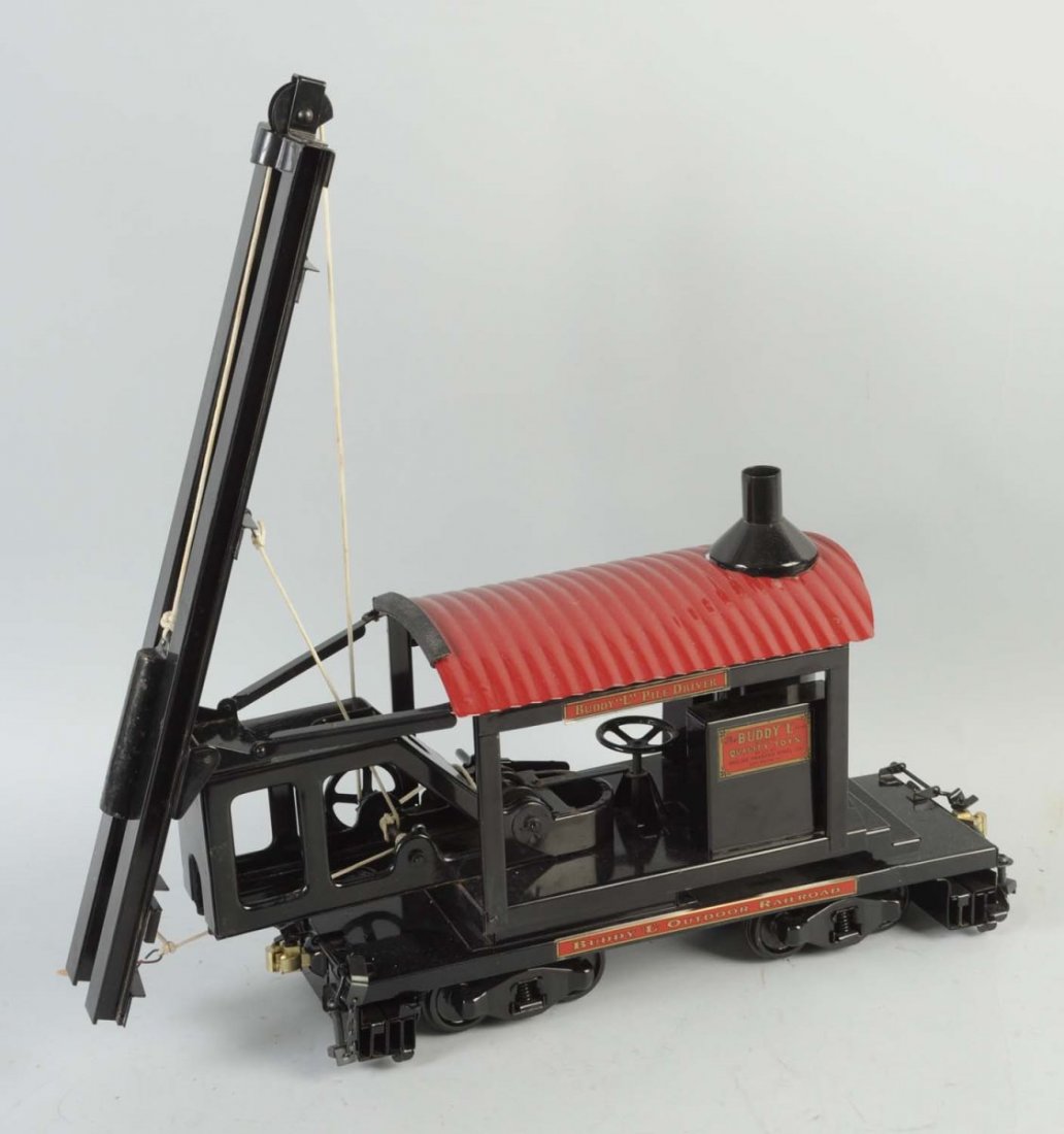 Pressed Steel Buddy L Railroad Pile Driver.: The toy has been professionally restored, and it only has a few very small scratches or chips throughout. The toy includes accessories. Condition (Excellent - Near Mint). Size 21" L.