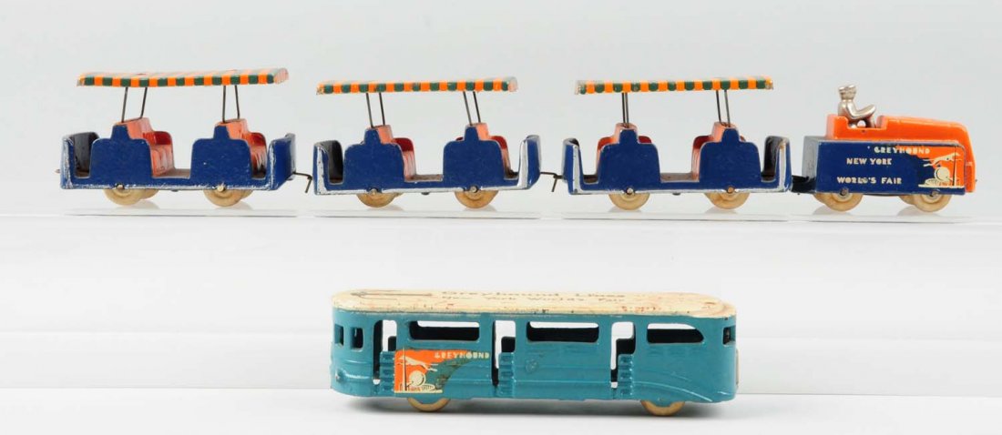 World's Fair Greyhound Train & Trolley Set.: Made by Arcade. The toys are made of cast iron and tin. There is some minor scratching throughout the toys. It appears that the passenger cars and the trolley have been