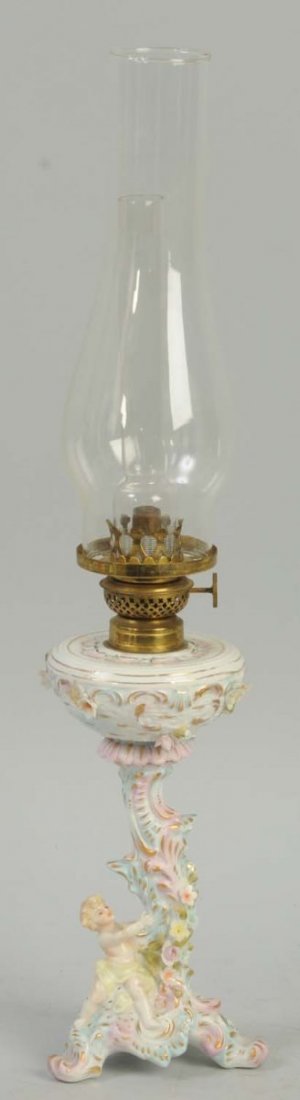Capo-de-Monte Type Oil Lamp.: This oil lamp has a porcelain base that depicts a cherub. Condition (Excellent). Size 21" L.