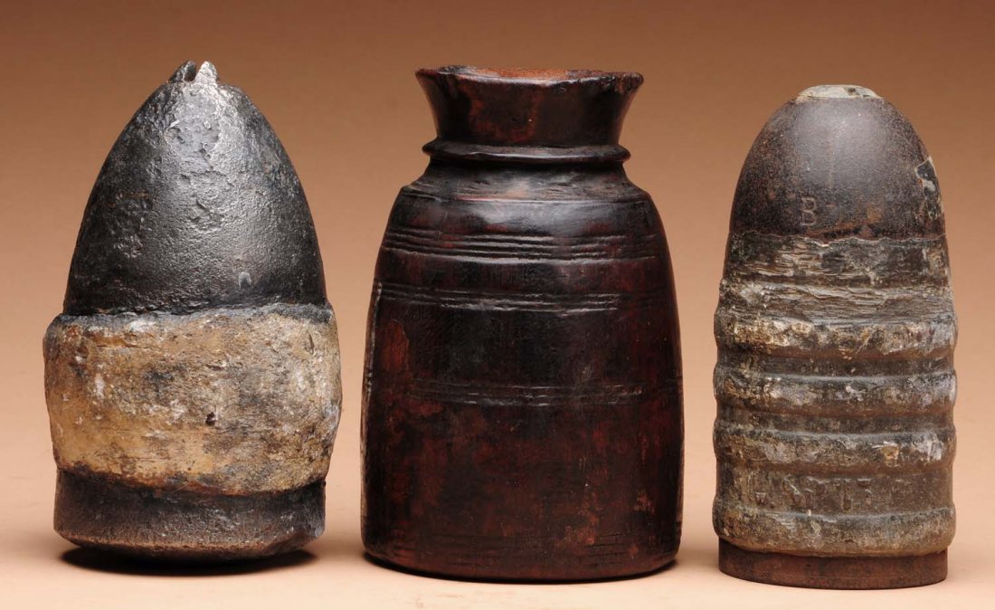 Civil War Projectile Lot.: This lot includes a leather canister full of 70 cal. musket balls and two large lead projectiles (cannon). Condition (Very Good). Size Largest : 6 - 1/2 L.
