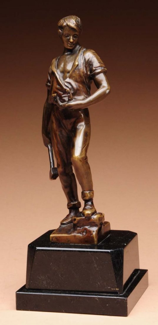 Beck Blacksmith.: Small bronze of a blacksmith holding a horseshoe and hammer. Inscribed: BECK. Excellent casting with a beautiful medium brown patina on a black marble base. There is a scuff in the finish on figure's 