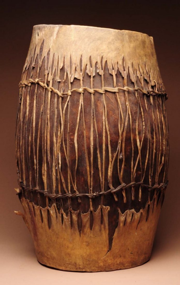 American Indian Made Wooden Drum.: Original rawhide top and bottom. Condition (Good). Size 25" T.
