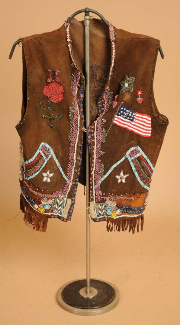 Indian Beaded Vest.: Probably used in a rodeo. Various old parts attached to vest. Commercial leather. Condition (Fair).