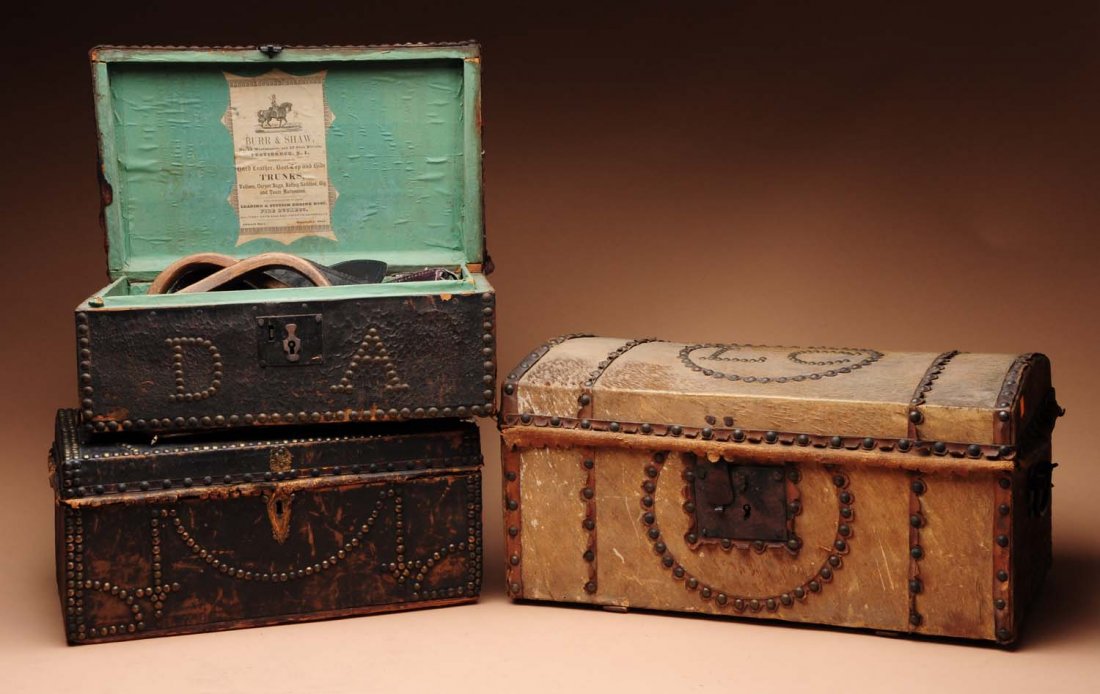 Lot of 3: Wooden Leather Bound Cases.: One with loose binding. Circa 1840-1860. One with missing handle, and one with horse stirrup, spurs and a holster. Condition (Fair - Good). Size Largest: 20" L.