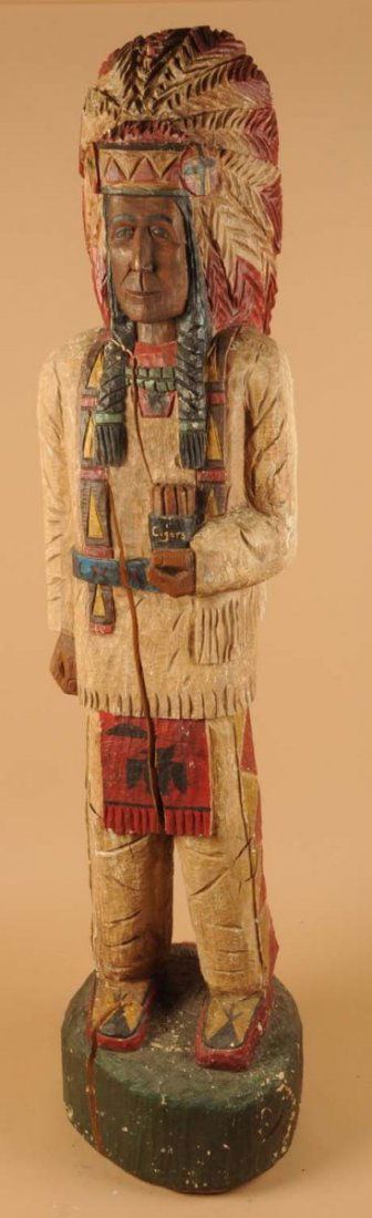 Carved Wooden Native American Figure.: This more recent cigar store Indian figure has multiple large cracks. Condition (Good). Size 84" T.