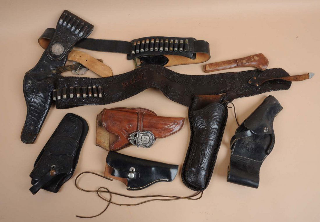 Lot of 7: Holsters.: Unmarked. One with attached badge marked "U.S. Deputy Marshall" which seems to have descent age to it. Condition (Fair - Good).