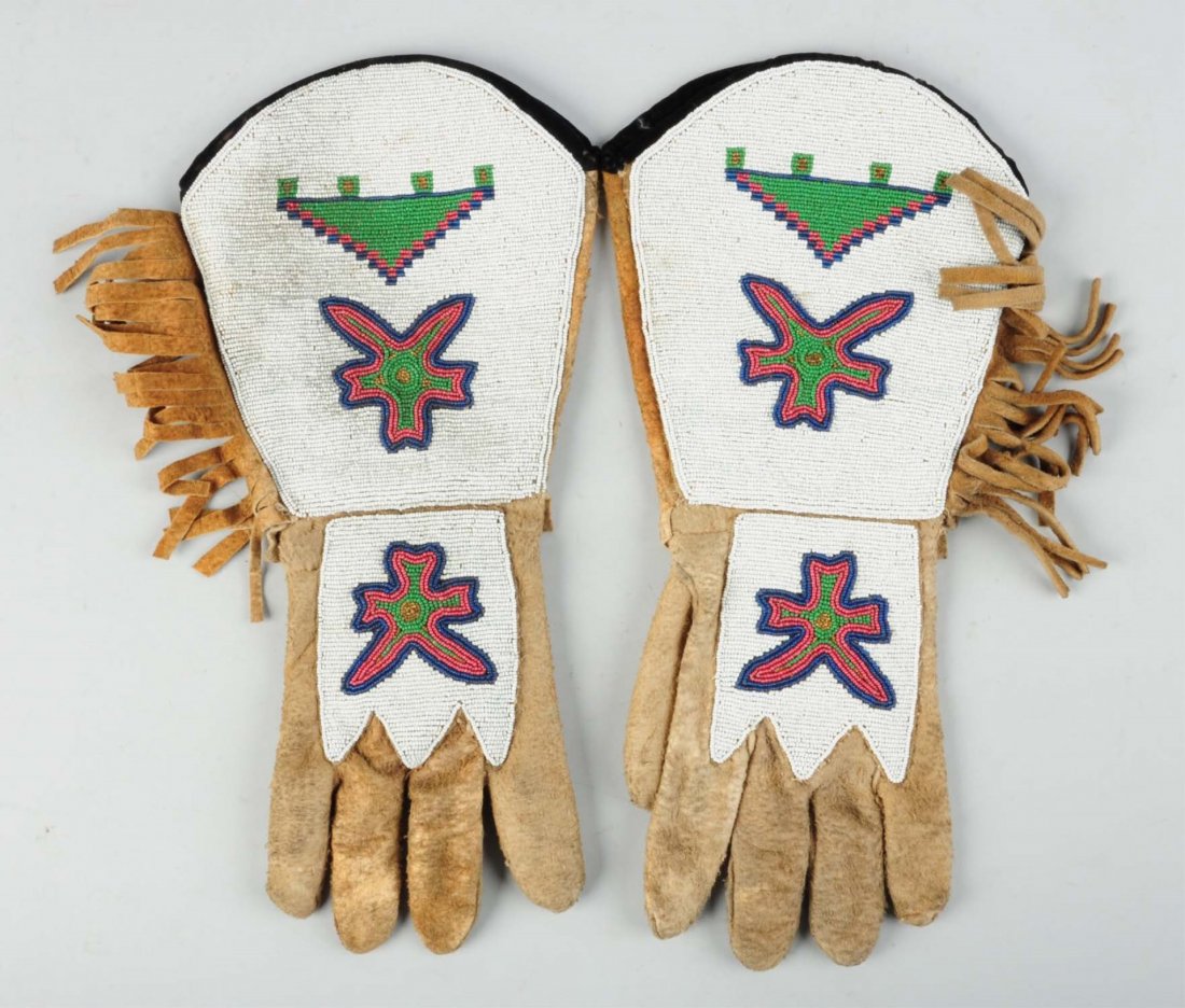 Northern Plains Beaded Gauntlet Gloves.: 1890s-1910. Thread and sinew stitching. Brain tan leather. Condition (Excellent). Size Each: 15 - 1/2" L.