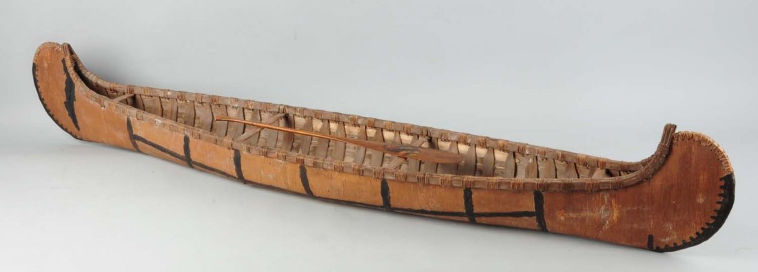 Old Large Native American-Made Birch Bark Canoe.: Circa 1930s-1940s. Hand-made from birch bark and wood. Includes small model paddle. Condition (Good). Size 74" L.