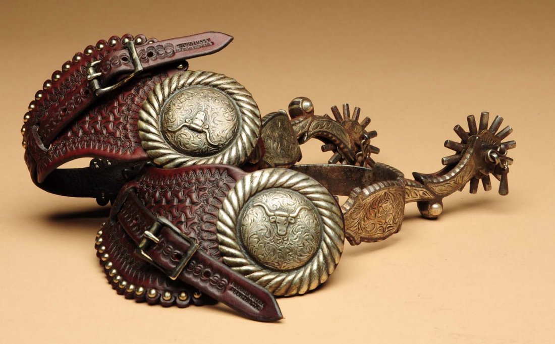 Pair of California Spurs: Late 19th century to early 20th century. With silver overlay and engraving. Show use, wear, and good age. Replaced straps signed "Buddy Foster, Decater, Texas". Condition (Good). Size Largest: 10" L.