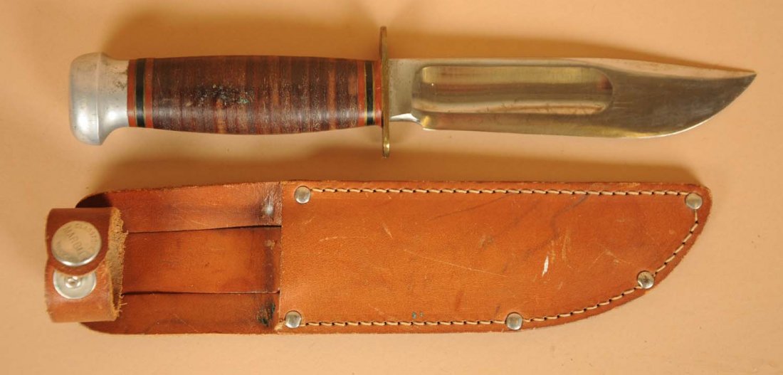 Marles Gladstone Mich. U.S.A Fixed Blade Knife.: Circa 1940s. Marbles "Ideal" sheath knife with a 5" blade, overall 9 - 1/16". Handle is stacked leather with brass guard and aluminum crown. Correct sheath with a signed safety snap included. Conditio