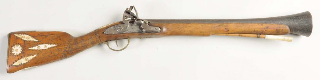 Crude Middle Eastern Flint Lock Blunderbus.: This is a fairly early example, yet crudely constructed blunderbuss with ill fitting parts, several ivory/bone inlays, bone-tipped cleaning rod, flint lock action in overall original condition.